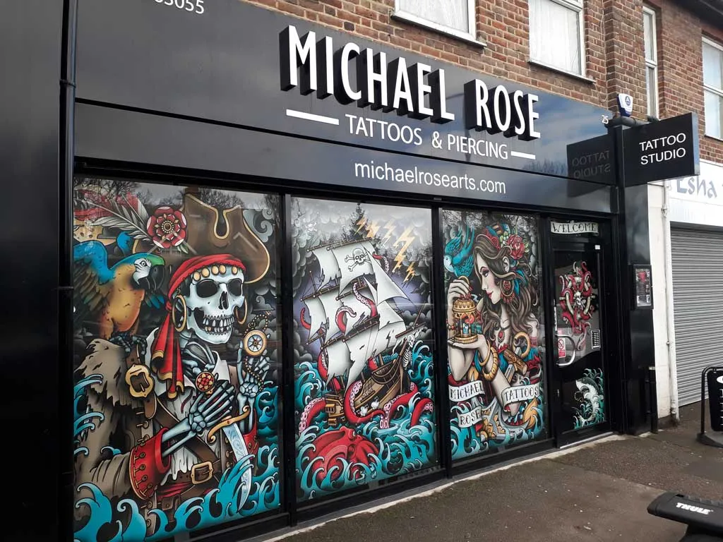 Tattoo studio shop front with fascia sign and full colour printed window graphics