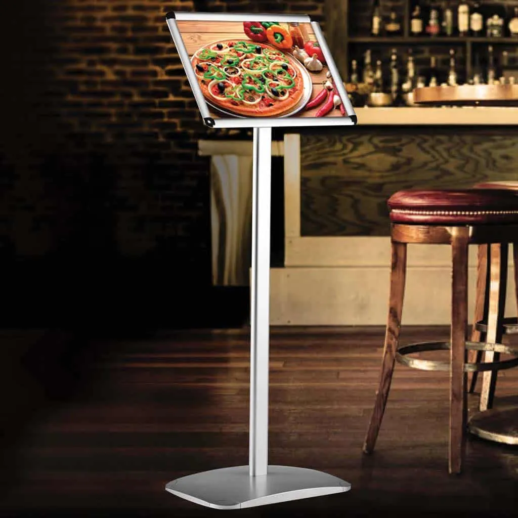Freestanding menu board displaying a pizza poster inside a bar