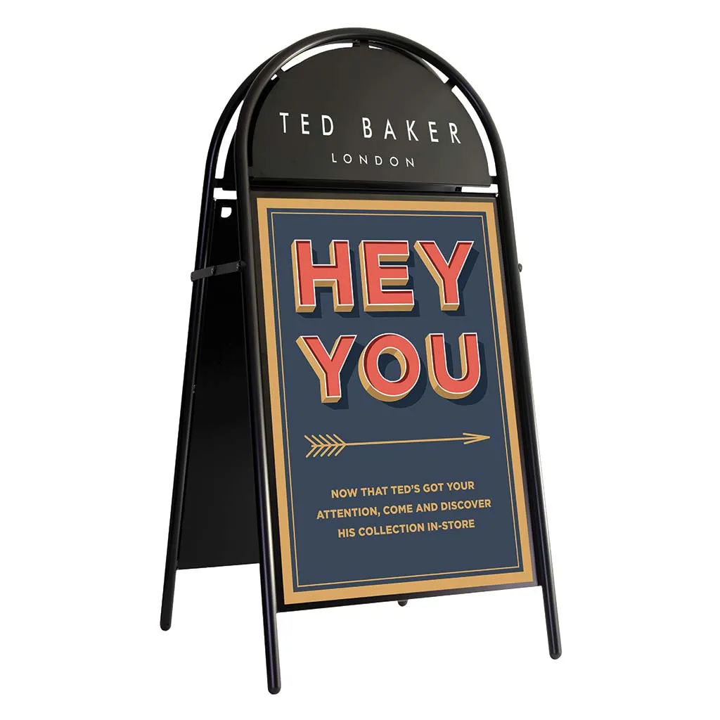 Black traditional pavement board carrying a Ted Baker poster