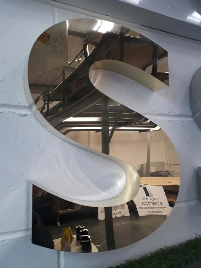 Letter S in polished mirror-finish brass