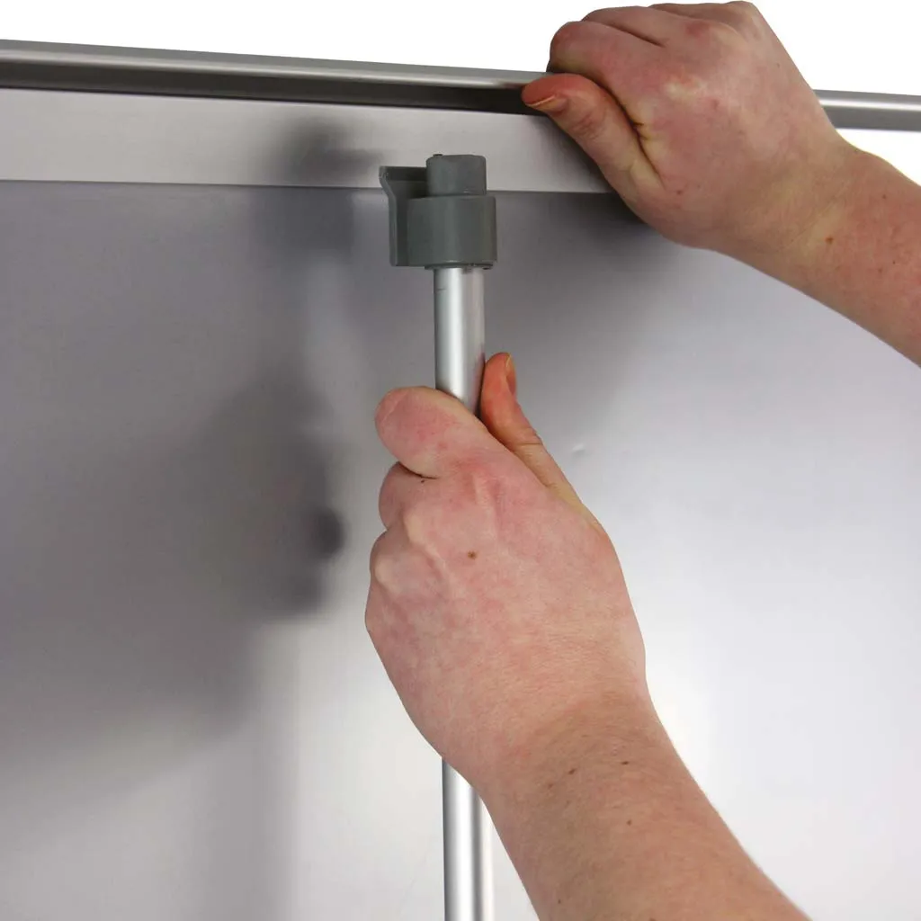 Roller banner graphic being clipped onto its support pole