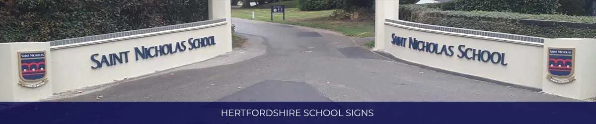 Saint Nicholas School entrance walls, each carrying the school name and crest either side of the driveway