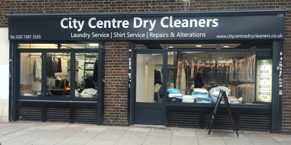 Fascia sign board above the City Centre Dry Cleaners shopfront in London