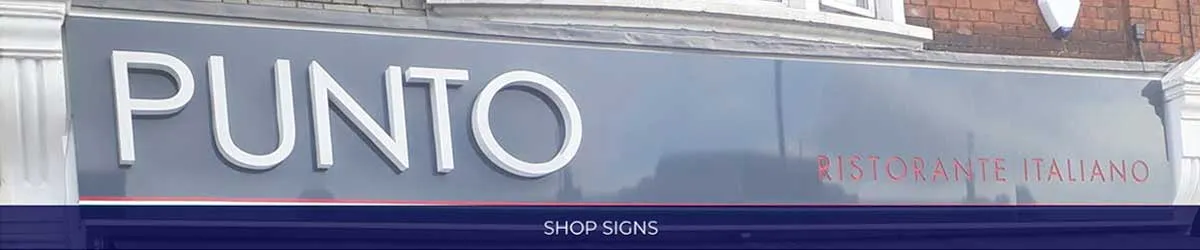 Illuminated PUNTO restaurant fascia sign running the width of a shop front