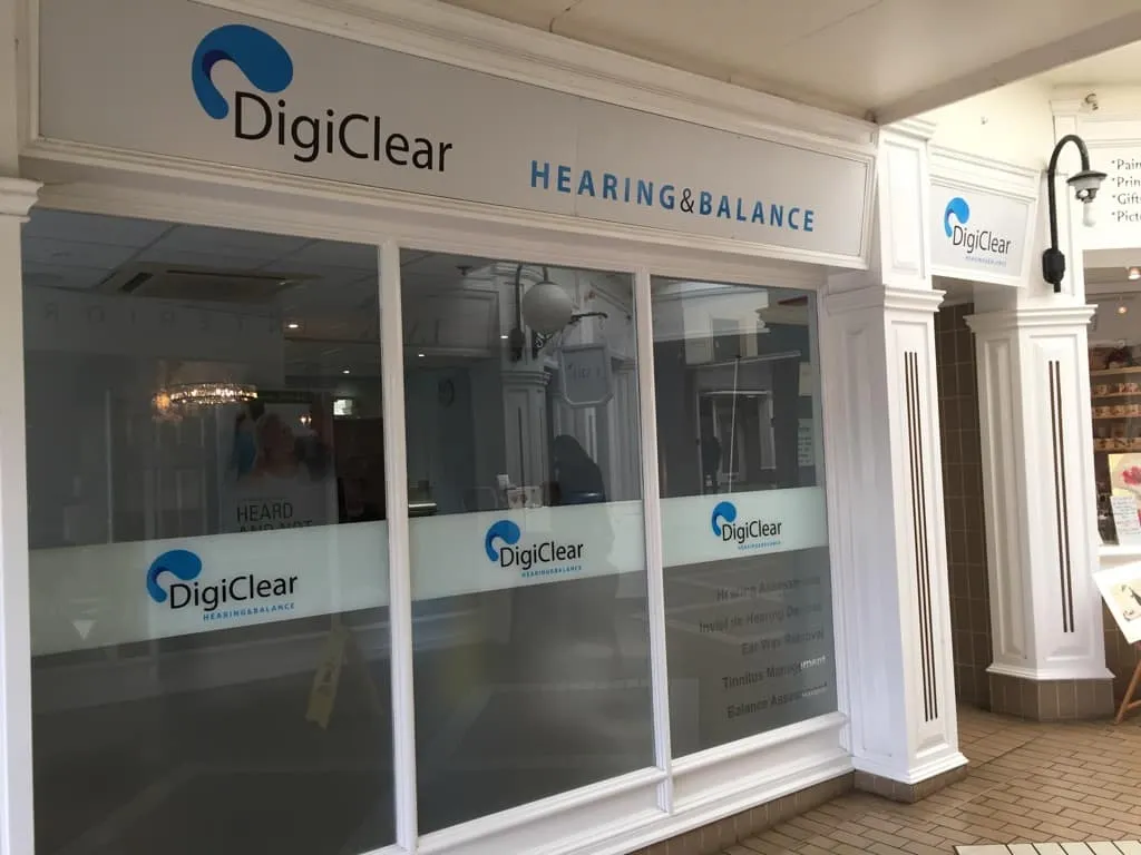 A white shopfront for DigiClear Hearing and Balance with matching window vinyls